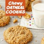 Orange white text overlay over image of grey background with oatmeal cookies, glass of milk, and loose walnut pieces.