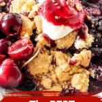 A serving of cherry dump cake with cream; dark red and white text overlay.