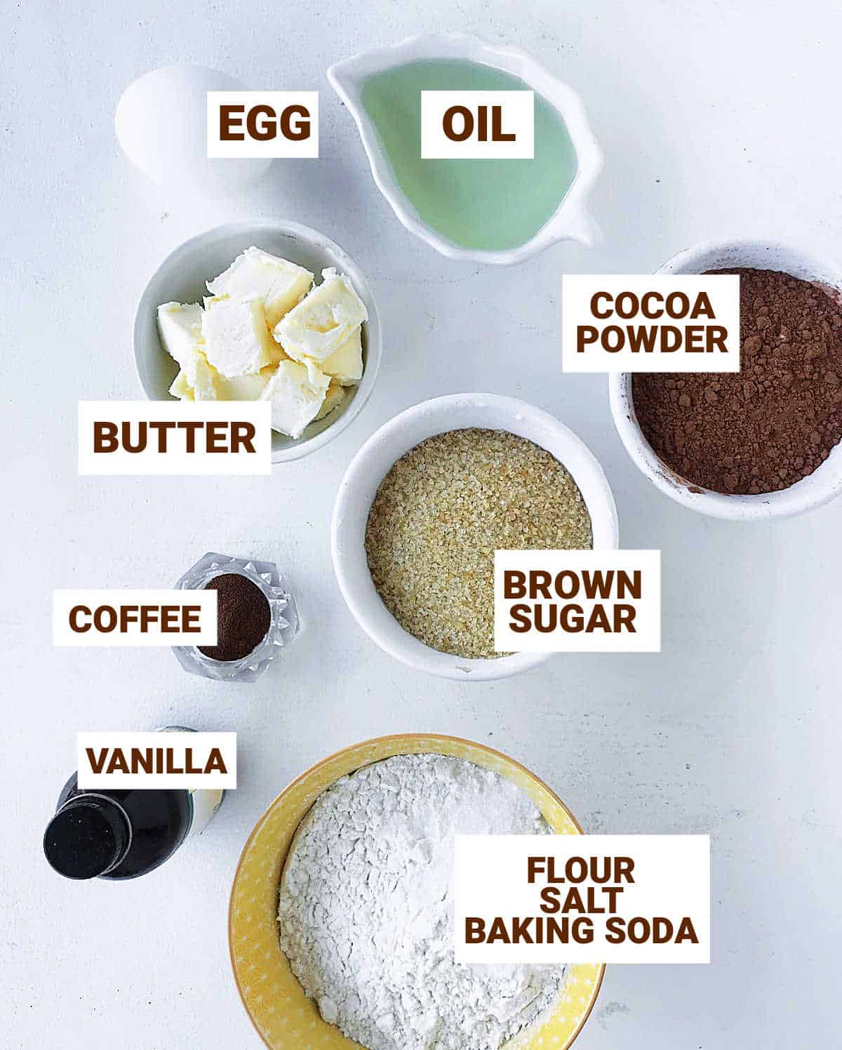 Different bowls with ingredients for chocolate whoopie pies, including egg, cocoa, vanilla; brown text overlay.