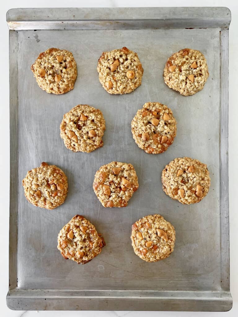 Metal cookie sheet with baked butterscotch oat cookies.