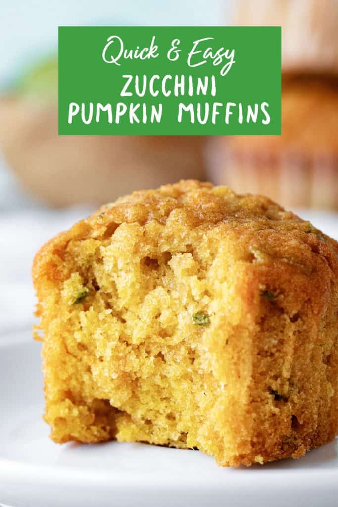 Close up of bitten pumpkin zucchini muffin on a white plate with green text overlay.