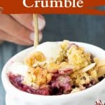Brown and white text overlay on image of white bowls with apple berry crisp and teal background.