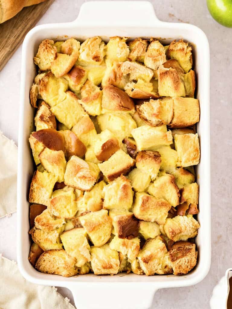Rectangular white dish with baked bread pudding. Top view.