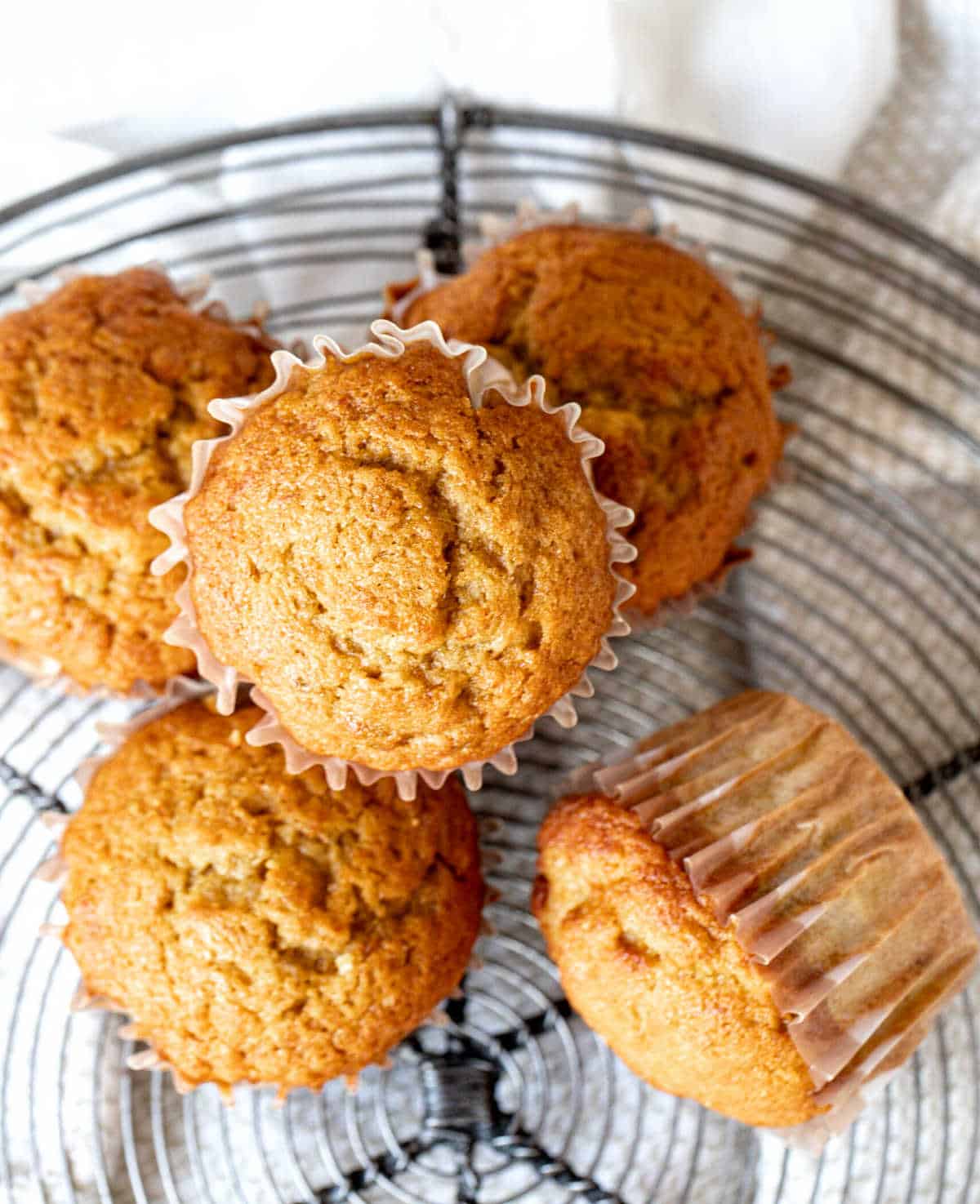 Top view of pumpkin banana muffins on a wire rack.