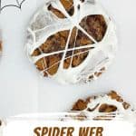 Chocolate cookie with marshmallow web on white paper. Brown and orange text overlay and graphic.