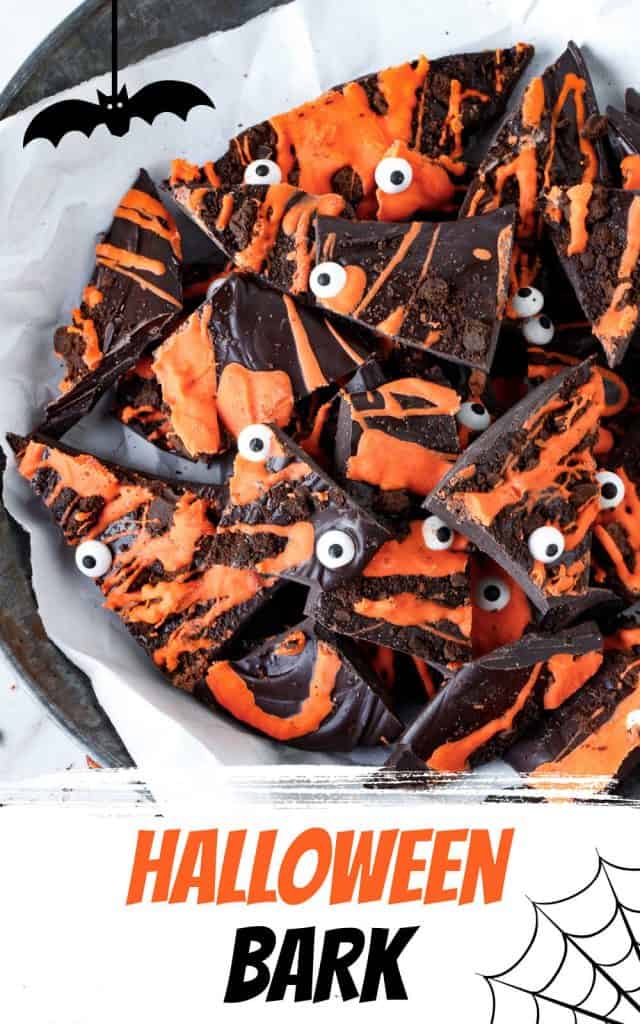 Orange and black text overlay on image of dark and orange chocolate bark with candy eyes.