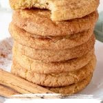Stack of snickerdoodles, top one bitten, with brown and orange text overlay.