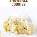 Eaten snowball cookie with powdered sugar on a white surface with brown and red text overlay.