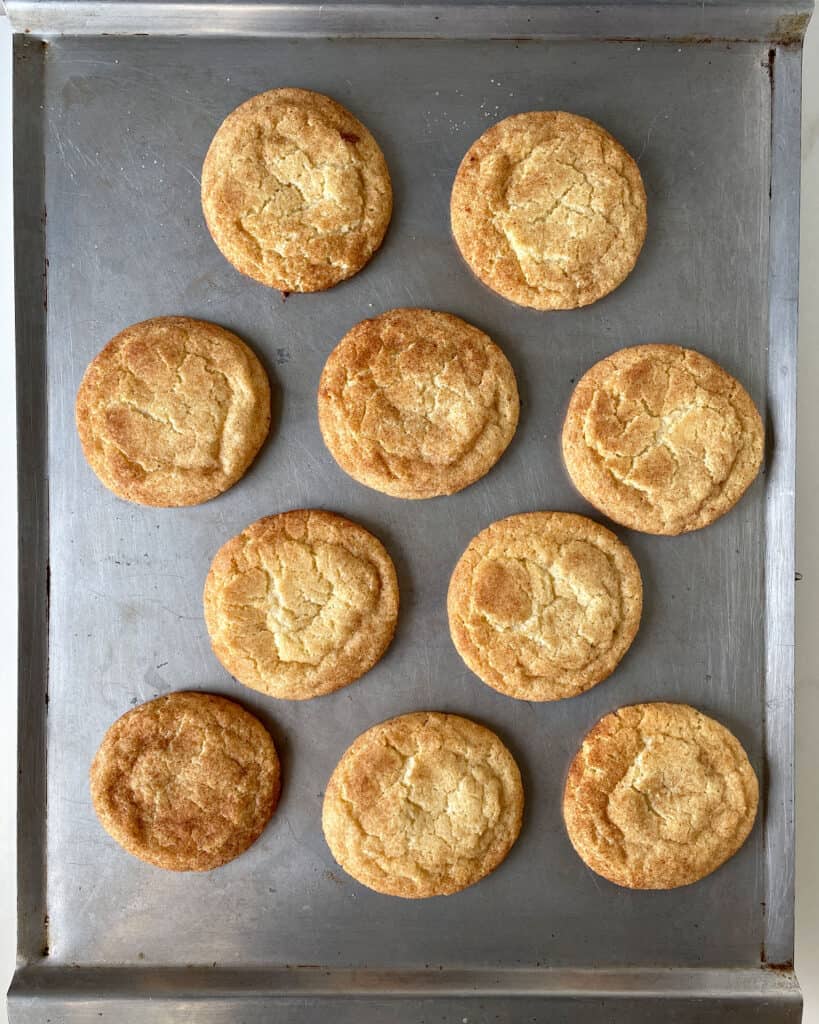 Top view of baked snickerdoodle cookies on the cookie sheet.