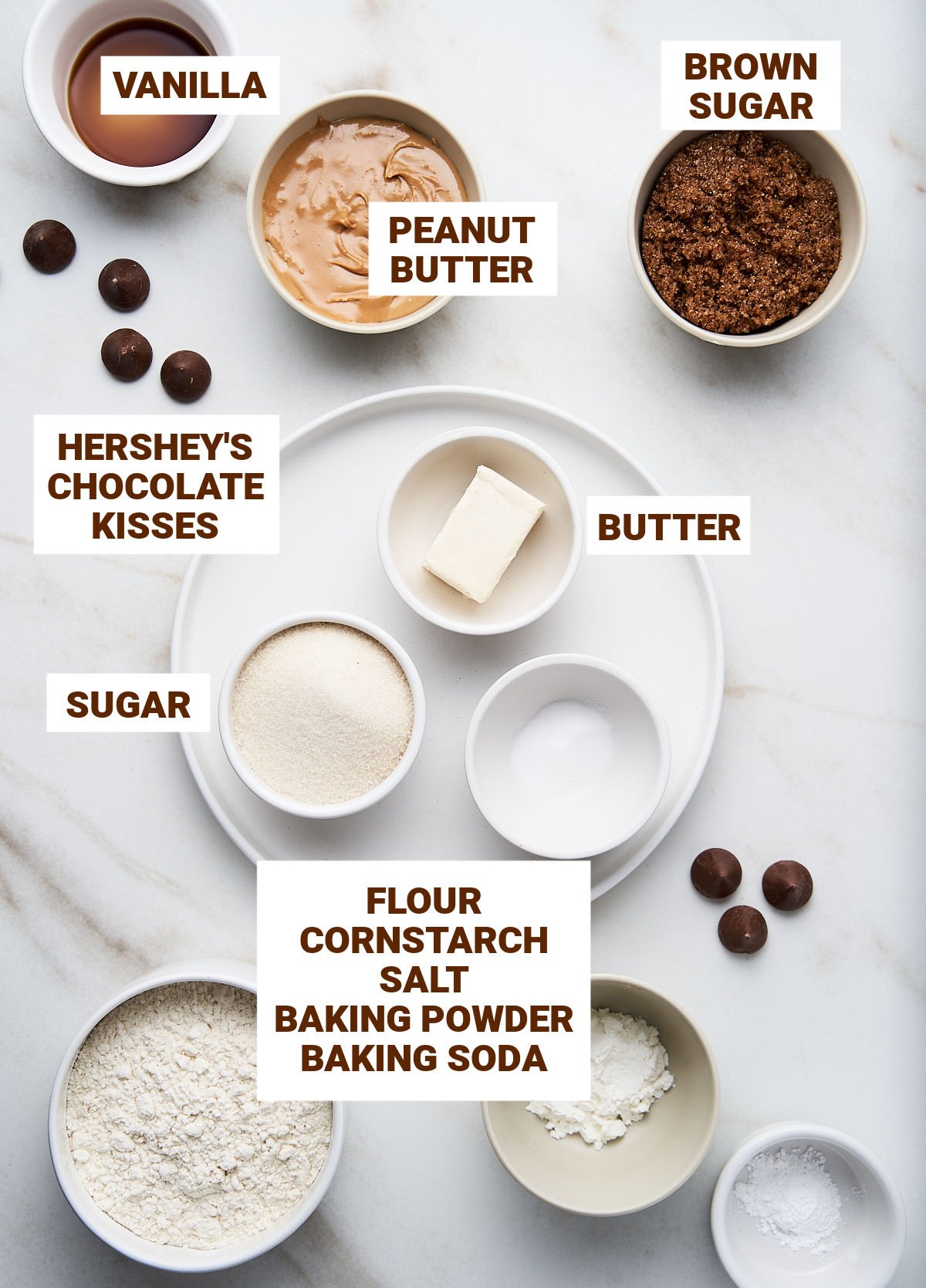 Ingredients for peanut butter cookies with chocolate kisses including flour mixture, brown and white sugar, vanilla, cornstarch.
