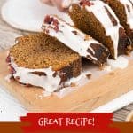 Brown, red, and white text overlay on image of glazed gingerbread loaf on a wooden board being cut.