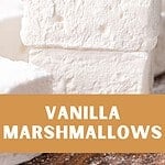 Brown, red and white text overlay on stack of vanilla marshmallows.