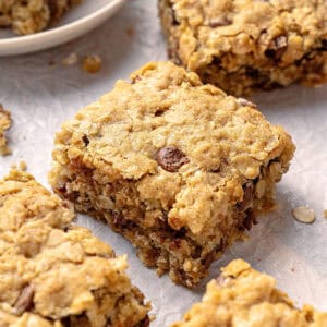 Oat chocolate chip squares close up on parchment paper.