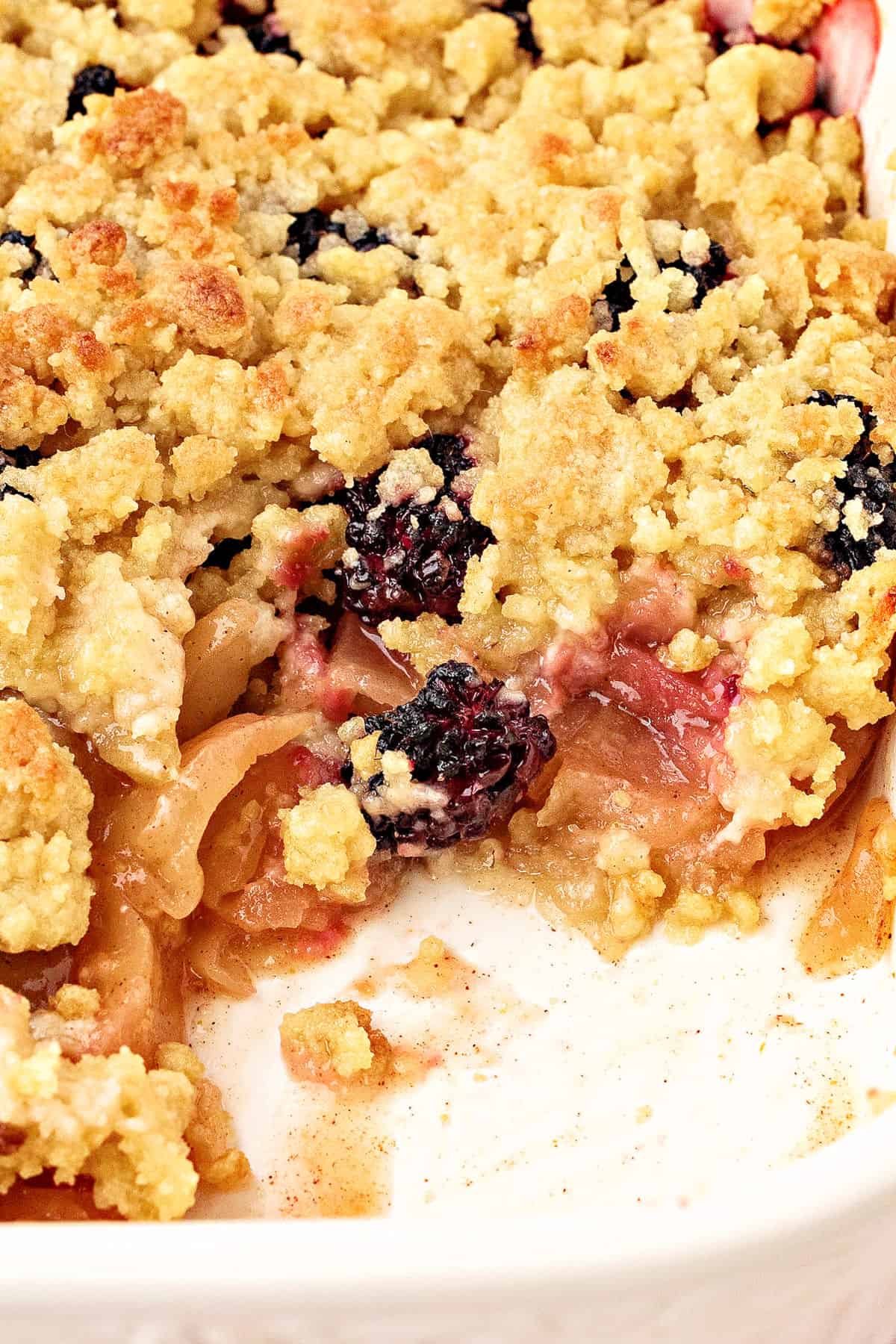 Baking dish with apple blackberry crumble; serving missing.
