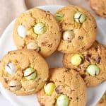 On a white plate, several mini egg vanilla cookies. Top view.