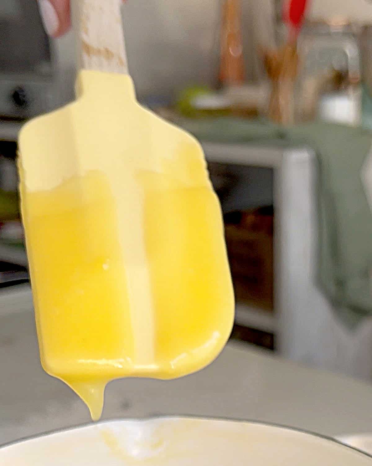 Yellow spatula with lemon curd.