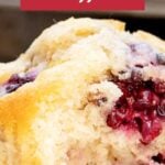 Red and white text overlay on close of bitten blackberry muffin.