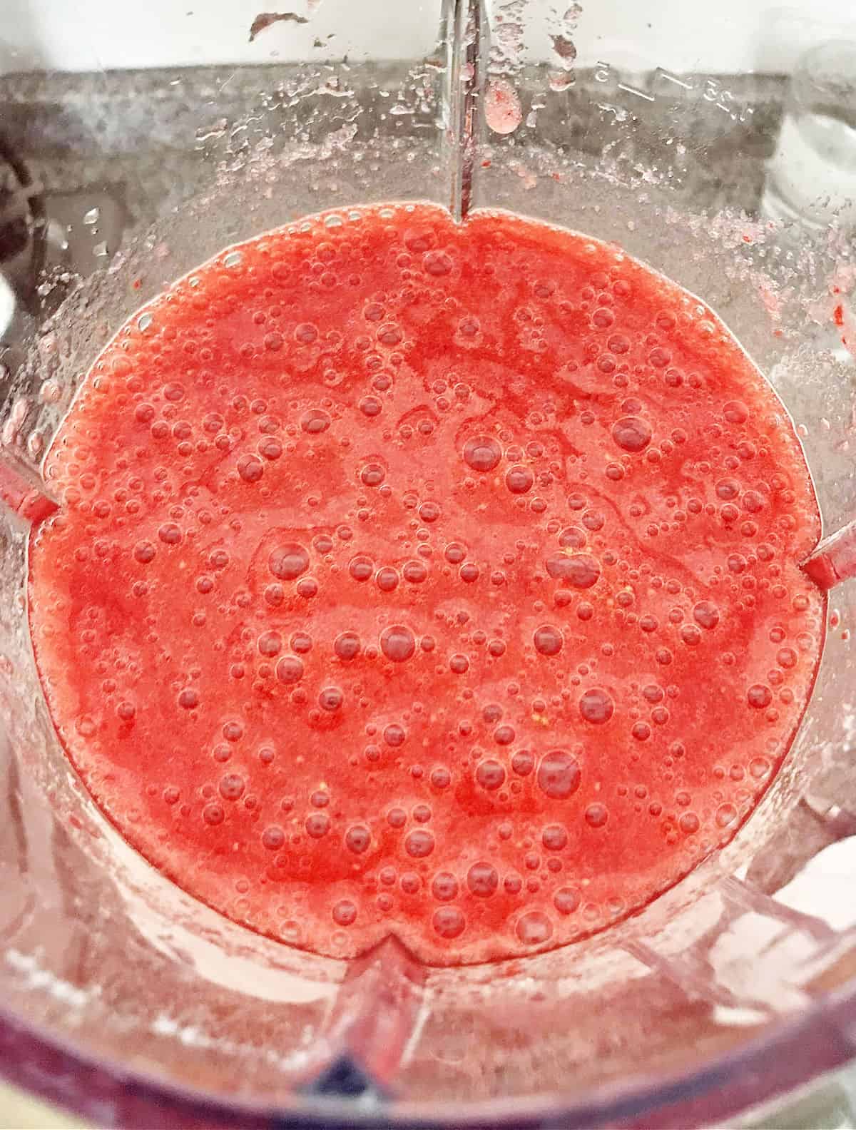 Overview of blender bowl with strawberry puree.