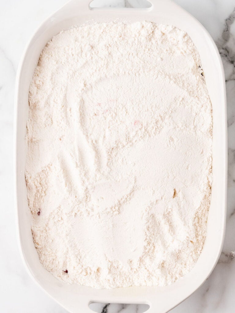 Dry cake mix topping in a white baking dish.