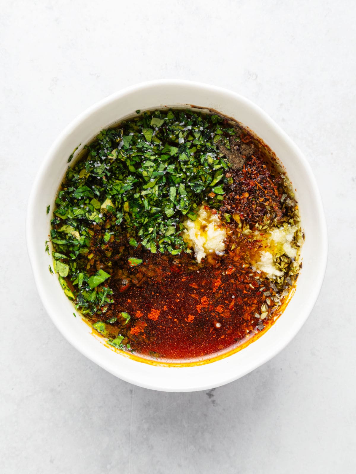 Chimichurri sauce in a white bowl.