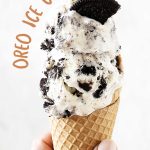 Beige text overlay on image of waffle cone with scoops of Oreo ice cream on a white background.