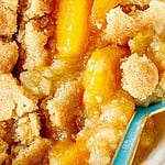 Close up peach cobbler with brown and teal text overlay.