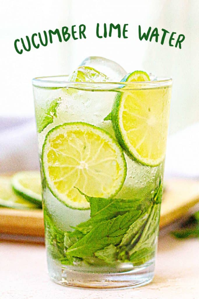 Green text overlay on glass of cucumber mint lime water. White background.