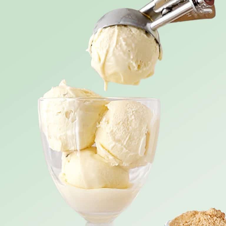 Green background with vanilla ice cream being scooped into a glass.