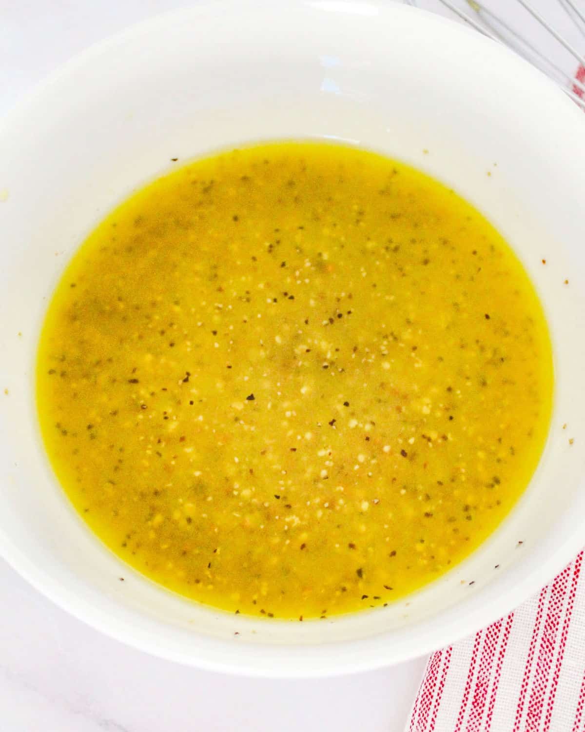 Mustard dressing in a white bowl.