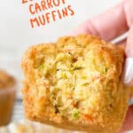 Orange and white text overlay on bitten zucchini carrot muffin being held.
