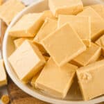 Close up pile of peanut butter fudge on a white plate.