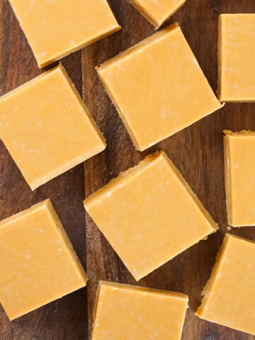 Top view of wooden board with dulce de leche squares.