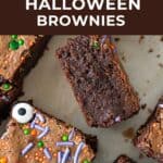 Orange, brown and white text overlay on close up image of halloween brownies.