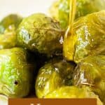 Brown and white text overlay on honey glaze being drizzled on top of Brussels sprouts.