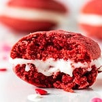 White and red text overlay on close up image of bitten red velvet whoopie pie.