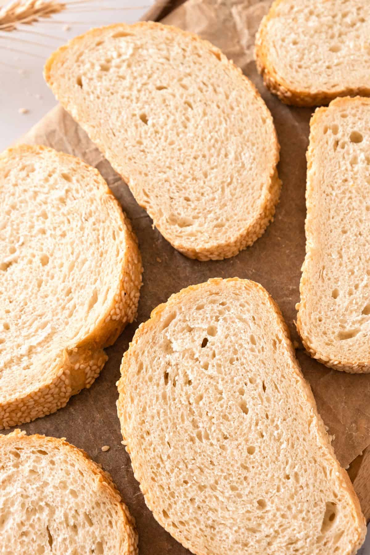 Flat slices of semolina bread on a wooden surface.