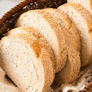 Close up slices of sesame semolina bread in a basket.