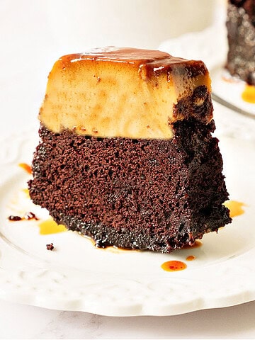 Slice of chocoflan on a white plate. White background.