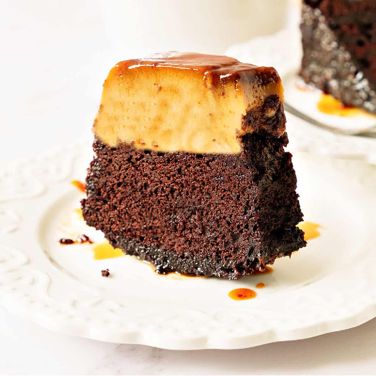 Slice of chocoflan on a white plate. White background.