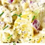 White, green and brown text overlay on close up image of creamy potato salad.