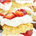 Brown and red text overlay on strawberry cream shortcake.