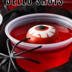 Black and white text overlay on a red jello cup with bloody eye candy. Black background.