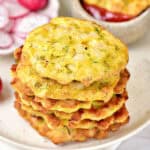 Stack of chicken fritters on a white plate.