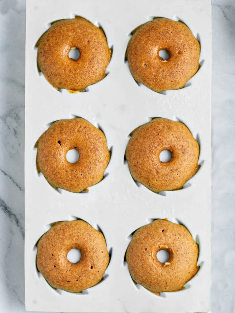 Baked pumpkin mini bundt cakes in a gray silicon mold. Top view.