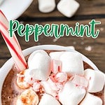 Brown and green text overlay on white mug with marshmallow mint hot chocolate.