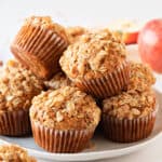 Oatmeal apple muffins on a white plate with a white background.