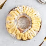 Pastry cream topped Easter ring on a light gray surface. Top view.