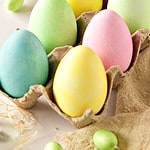 Brown, pink and white text overlay on cartoon with colored eggs.