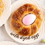 Lilac and brown text overlay on white plates with Easter braids with colored eggs.