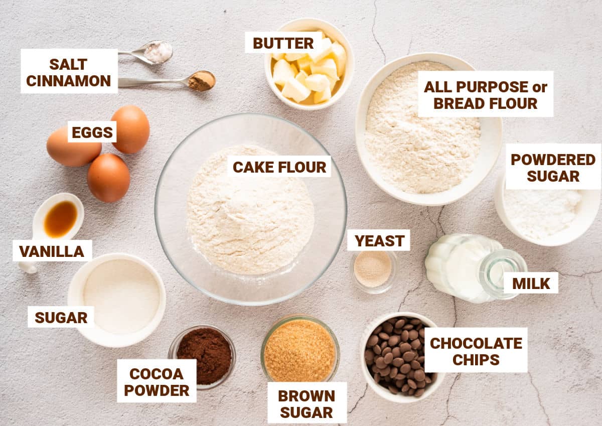 Light gray surface with bowls containing ingredients for chocolate cinnamon rolls.
